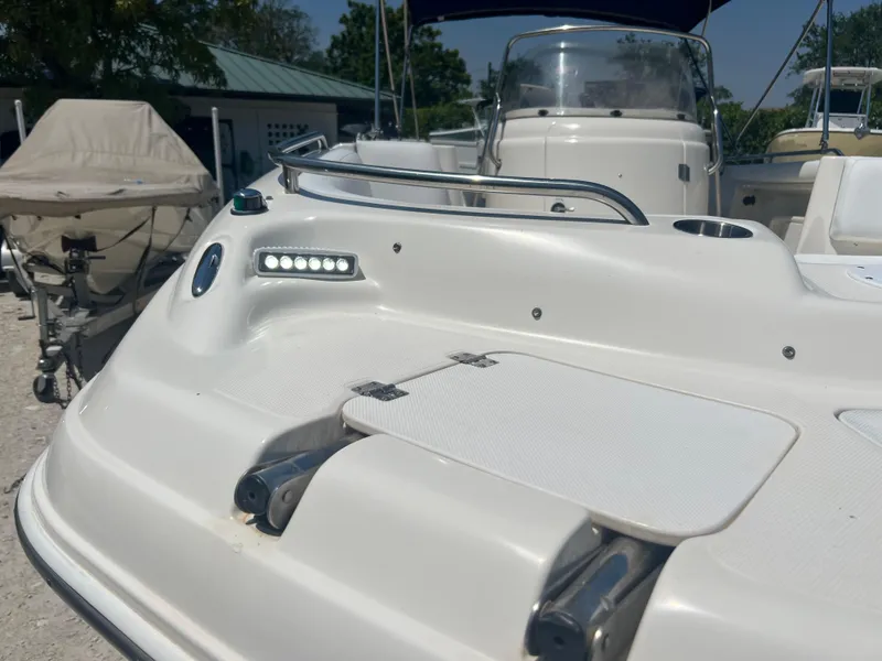 Slide: The Image of 2007 Hurricane 231 boat deck with stainless steel rail and storage compartments. - 23