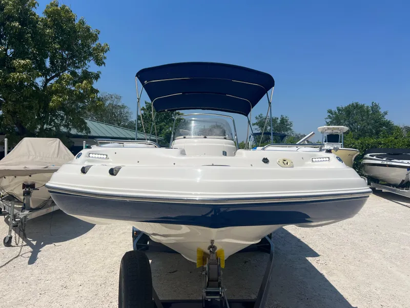 Slide: The Image of 2007 Hurricane 231 boat with blue canopy on trailer, front view. - 3