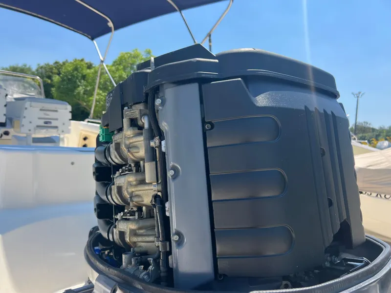 Slide: The Image of 2007 Hurricane 231 boat engine close-up under blue sky. - 30