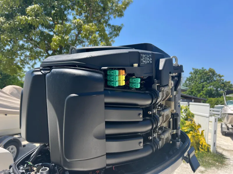 Slide: The Image of Close-up of a 2007 Hurricane 231 boat engine in a sunny outdoor setting. - 31