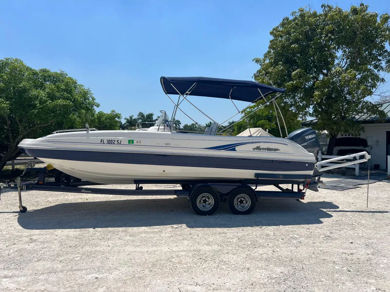 Slide: The Image of 2007 Hurricane 231 boat on a trailer with blue canopy. - 33