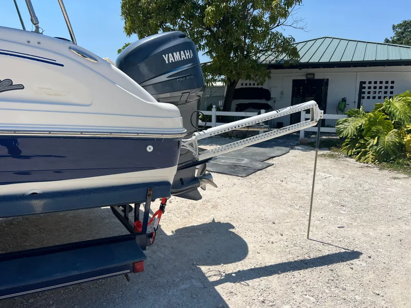 Slide: The Image of 2007 Hurricane 231 boat with Yamaha outboard motor in a sunny yard. - 34
