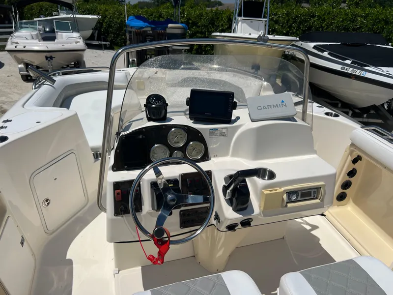Slide: The Image of 2007 Hurricane 231 boat dashboard with Garmin GPS and steering wheel. - 36
