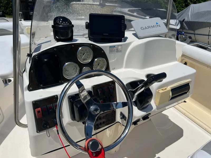 Slide: The Image of 2007 Hurricane 231 boat dashboard with Garmin GPS and steering wheel. - 38