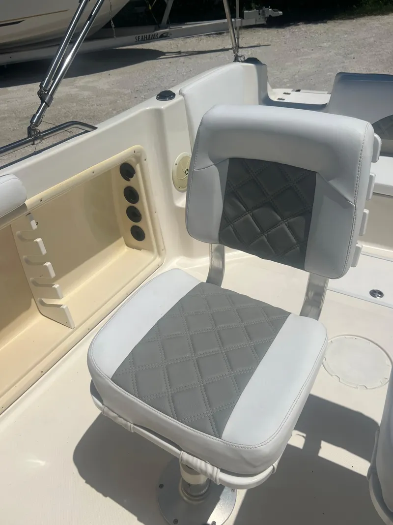 Slide: The Image of 2007 Hurricane 231 boat seat with gray and white upholstery. - 42