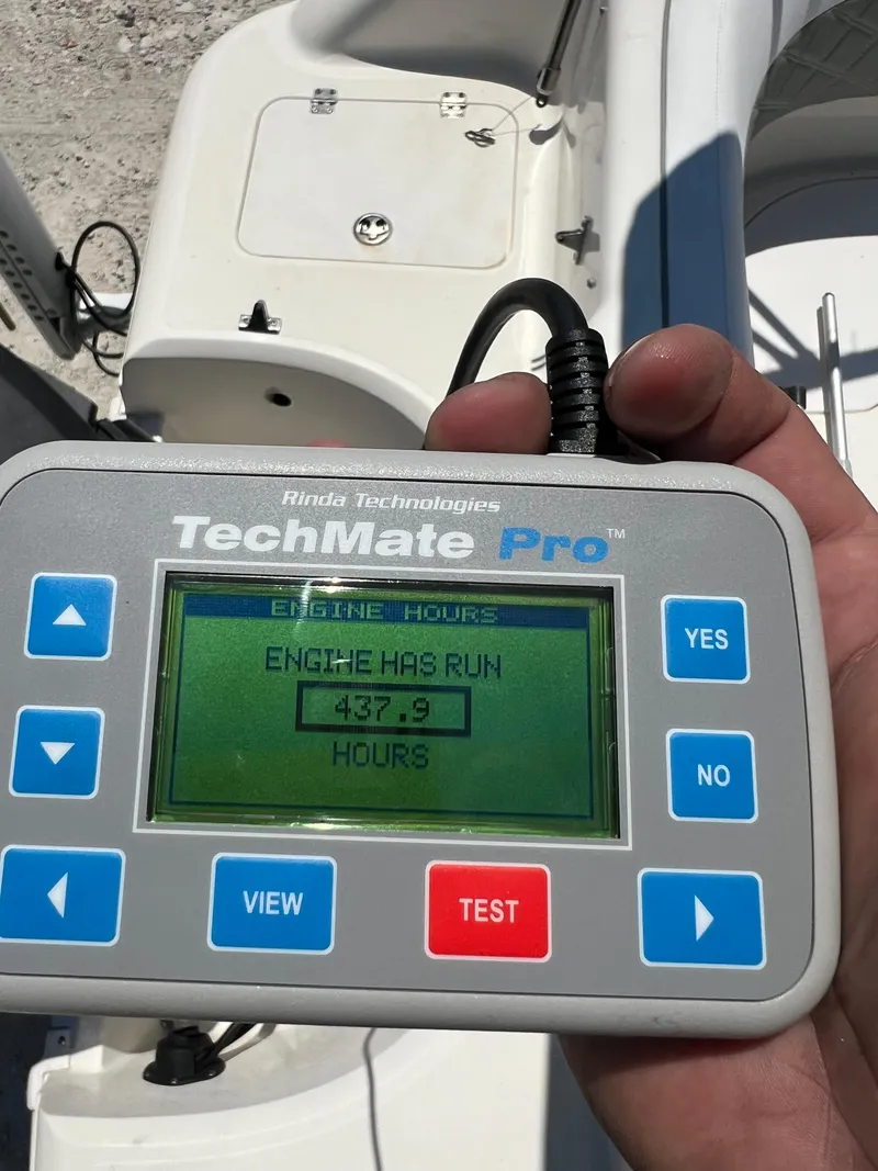Slide: The Image of Hand holding TechMate Pro displaying 437.9 engine hours on a 2007 Hurricane 231 boat. - 46