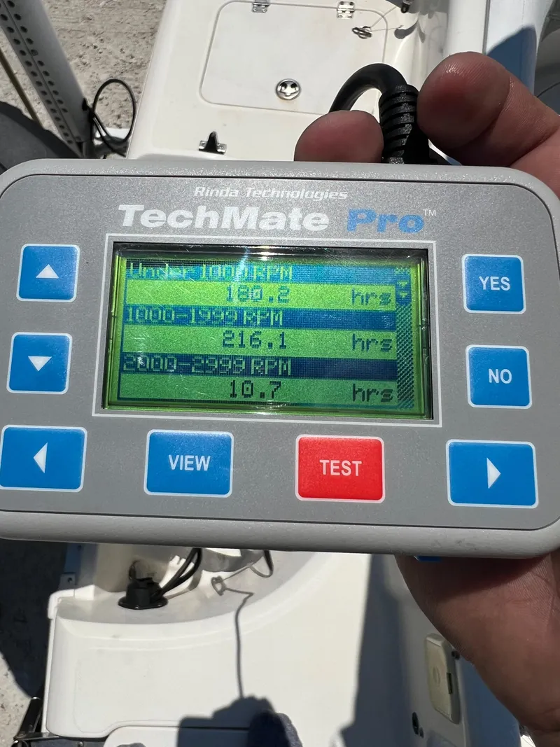 Slide: The Image of Hand holding TechMate Pro diagnostic tool displaying engine hours for 2007 Hurricane 231 boat. - 47