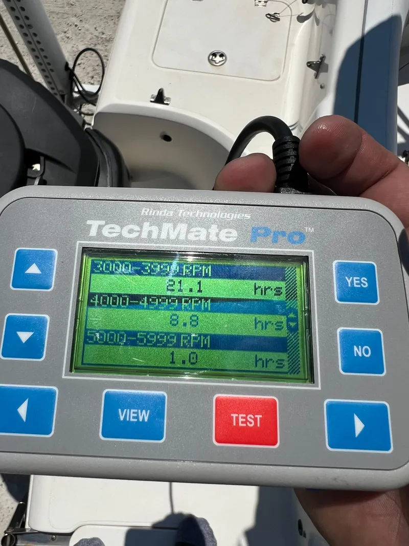 Slide: The Image of Hand holding TechMate Pro diagnostic tool displaying engine RPM data for 2007 Hurricane 231 boat. - 48