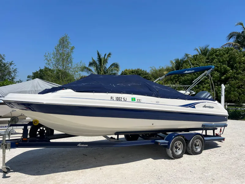 Slide: The Image of 2007 Hurricane 231 boat on a trailer with a blue cover. - 5