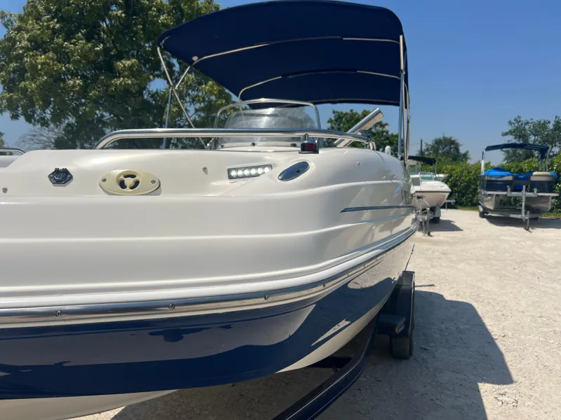 Slide: The Image of 2007 Hurricane 231 boat with blue canopy on a sunny day. - 9