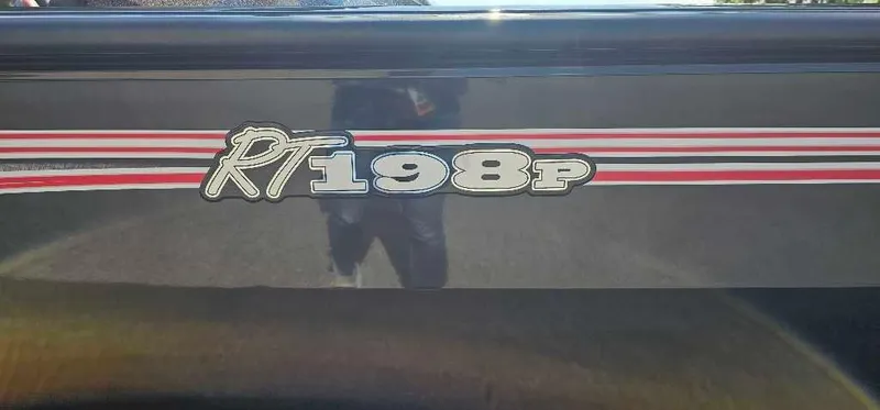 Slide: The Image of 2024 Ranger RT198P boat model logo with red and white stripes. - 2