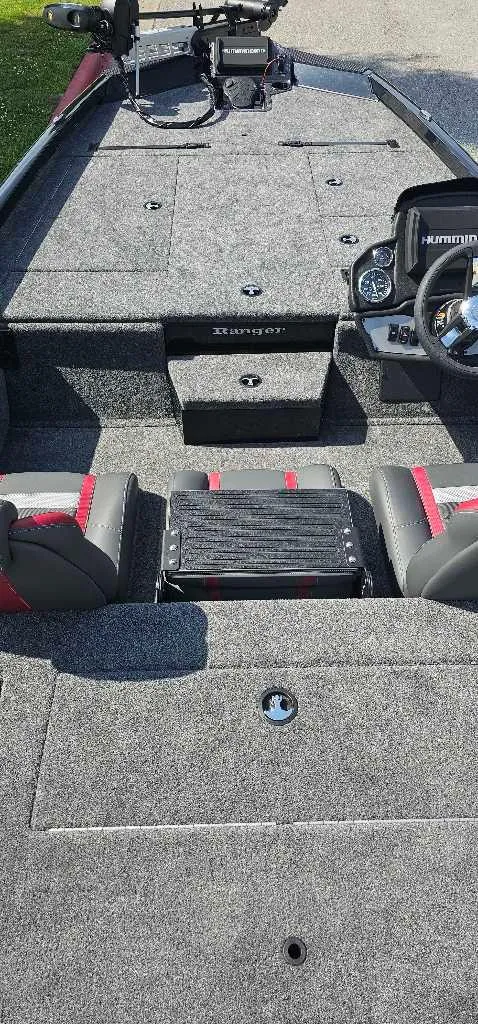 Slide: The Image of 2024 Ranger RT198P fishing boat interior with gray carpet and red-accented seats. - 3