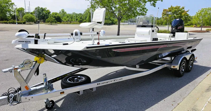 Slide: The Image of 2024 Ranger RB210 boat on a trailer in a parking lot. - 3