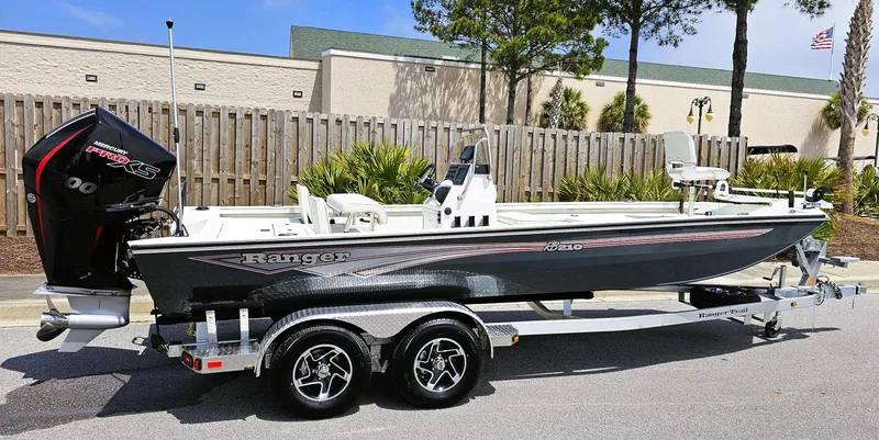 Slide: The Image of 2024 Ranger RB210 boat on a trailer, parked outdoors. - 9