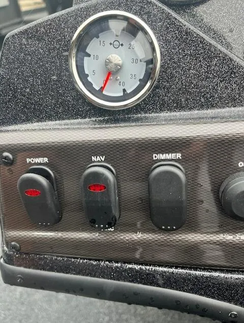 Slide: The Image of Control panel of a 2024 Nitro Z18 boat with power, nav, and dimmer switches. - 14