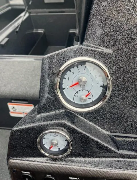 Slide: The Image of 2024 Nitro Z18 boat dashboard with gauges and controls. - 15