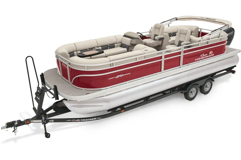 The Image of 2024 Sun Tracker Party Barge 24 DLX pontoon boat on trailer, parked outdoors. - 0