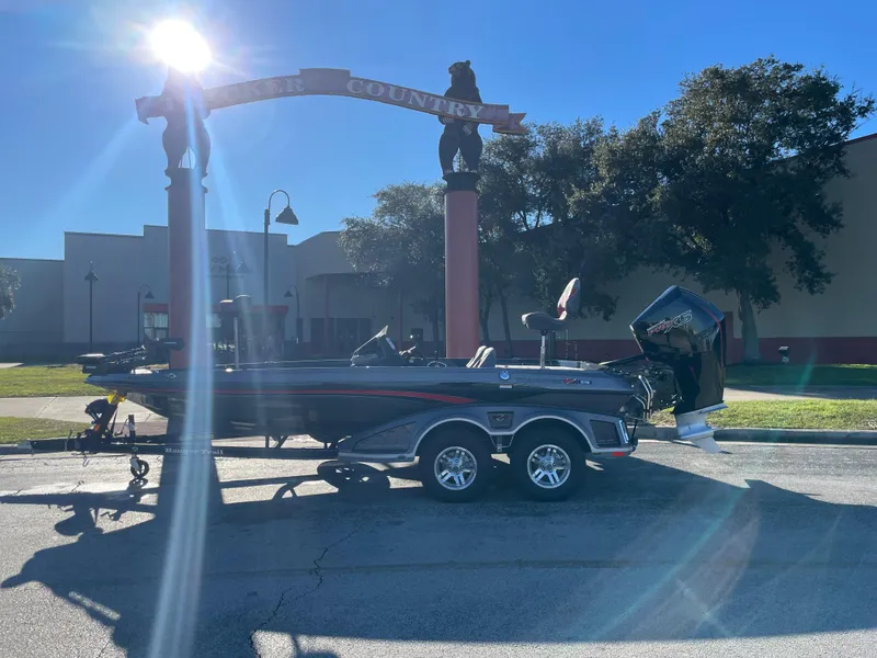 Slide: The Image of 2024 Ranger Z519 Ranger Cup boat parked outdoors in sunny setting. - 0