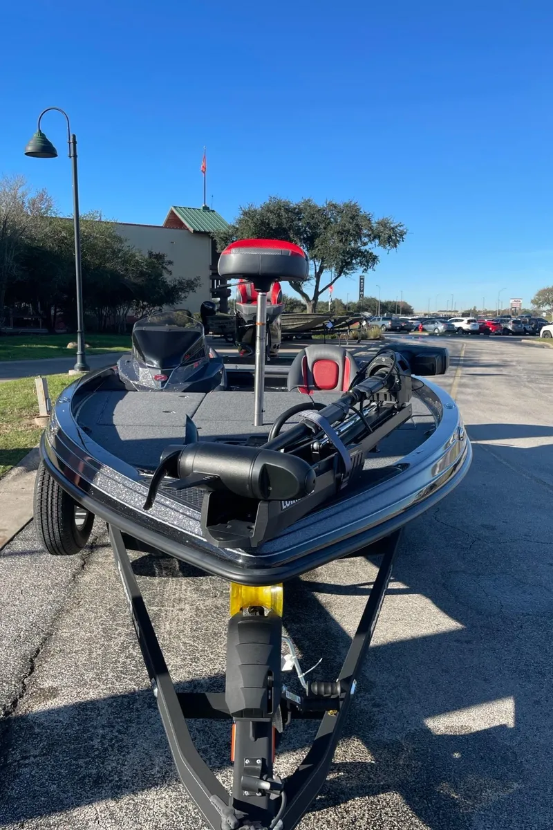 Slide: The Image of 2024 Ranger Z519 Ranger Cup Equipped boat on a trailer, parked outdoors. - 2