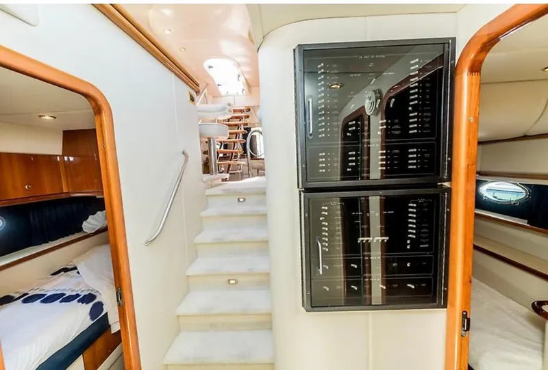 Slide: The Image of Interior of 1997 Sunseeker MANHATTAN yacht, featuring stairs, control panels, and cozy cabins. - 10