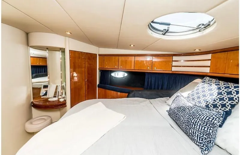 Slide: The Image of Luxurious 1997 Sunseeker MANHATTAN yacht bedroom with elegant wood finishes and plush bedding. - 13
