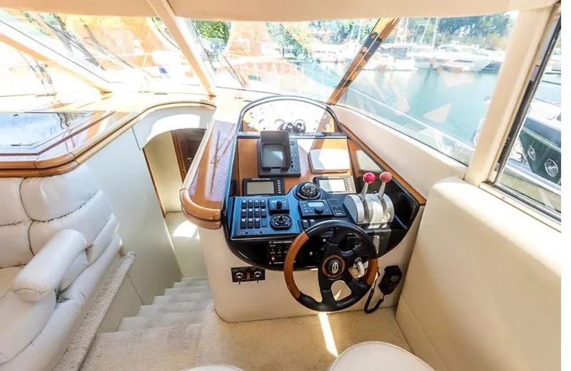 Slide: The Image of Luxurious 1997 Sunseeker Manhattan yacht helm with modern controls and panoramic view. - 18