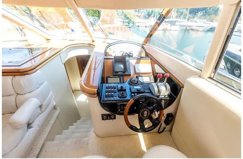 Slide: The Image of Interior helm of 1997 Sunseeker Manhattan yacht with steering wheel and control panel. - 19