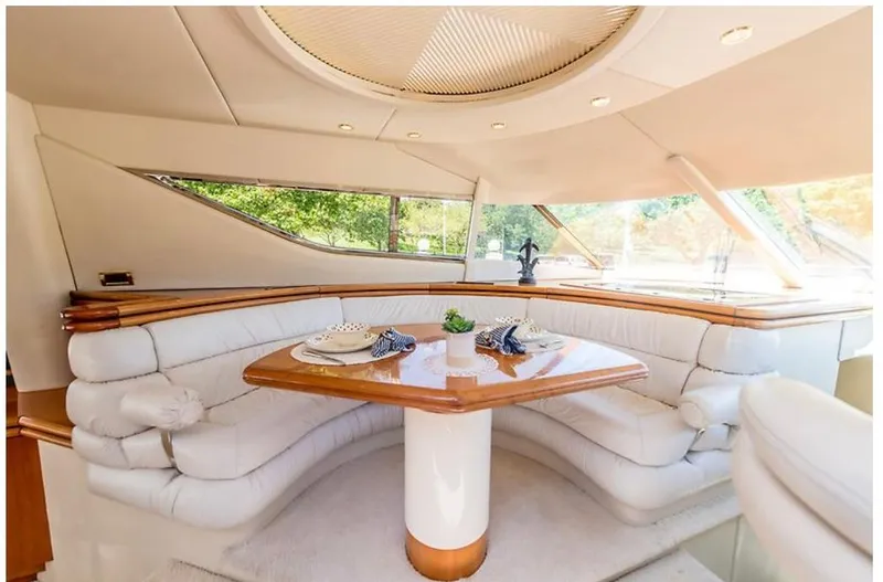 Slide: The Image of Luxurious interior of a 1997 Sunseeker MANHATTAN yacht with elegant seating and dining area. - 20