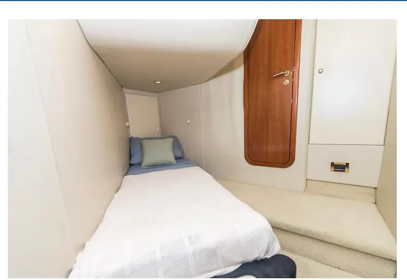Slide: The Image of 1997 Sunseeker MANHATTAN yacht cabin with single bed, wooden door, and cozy interior. - 25