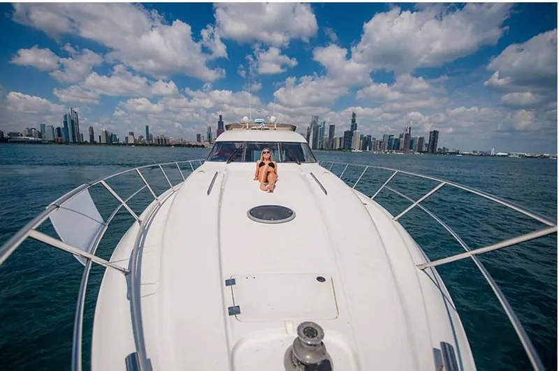 Slide: The Image of 1997 Sunseeker MANHATTAN yacht cruising with city skyline in the background. - 31