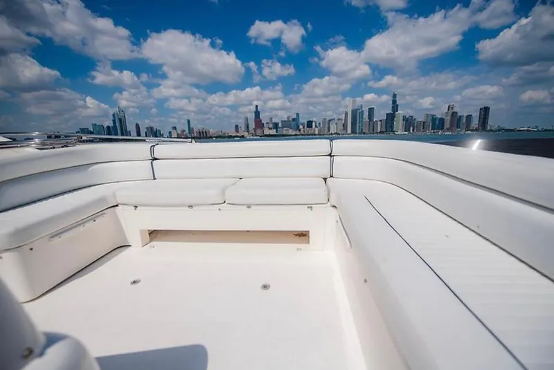 Slide: The Image of Sunseeker MANHATTAN 1997 yacht with white seating, city skyline, and blue sky. - 32