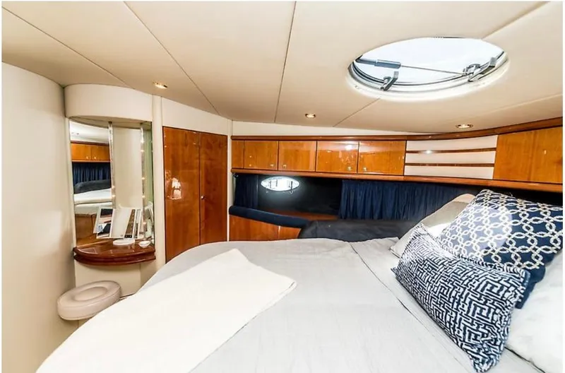 Slide: The Image of Luxurious 1997 Sunseeker Manhattan yacht bedroom with elegant wood finishes and plush bedding. - 37