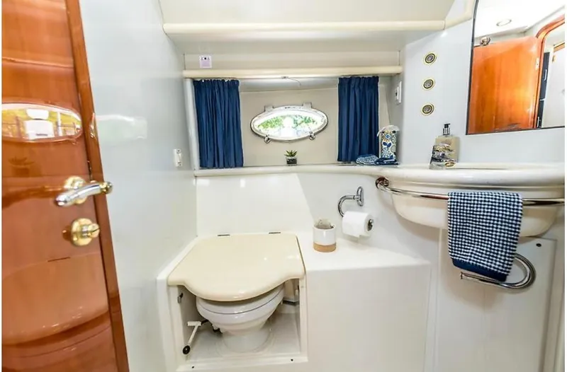 Slide: The Image of Luxurious 1997 Sunseeker MANHATTAN yacht bathroom with elegant fixtures and blue accents. - 38