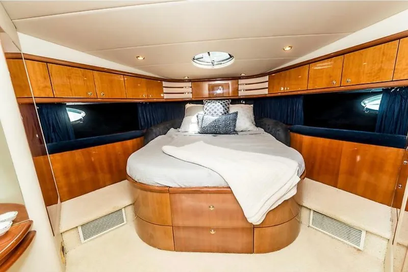 Slide: The Image of Luxurious bedroom interior of 1997 Sunseeker Manhattan yacht with wood cabinetry and round bed. - 4