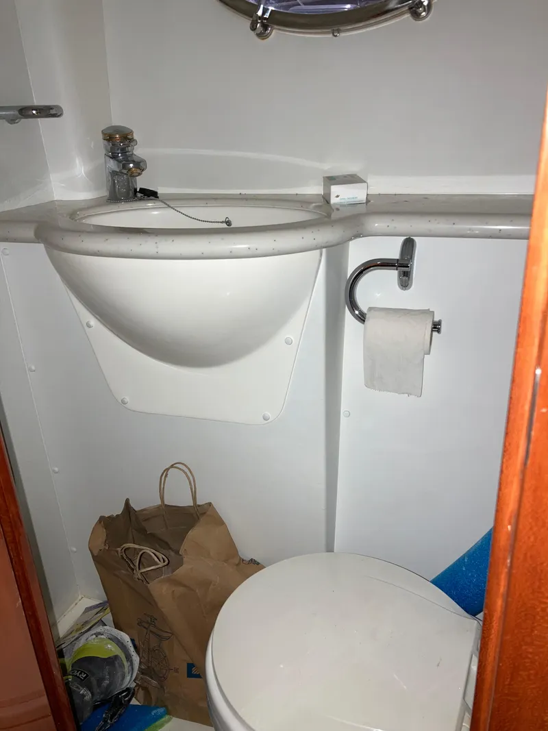 Slide: The Image of Compact bathroom in a 1997 Sunseeker MANHATTAN yacht, featuring a sink and toilet. - 43