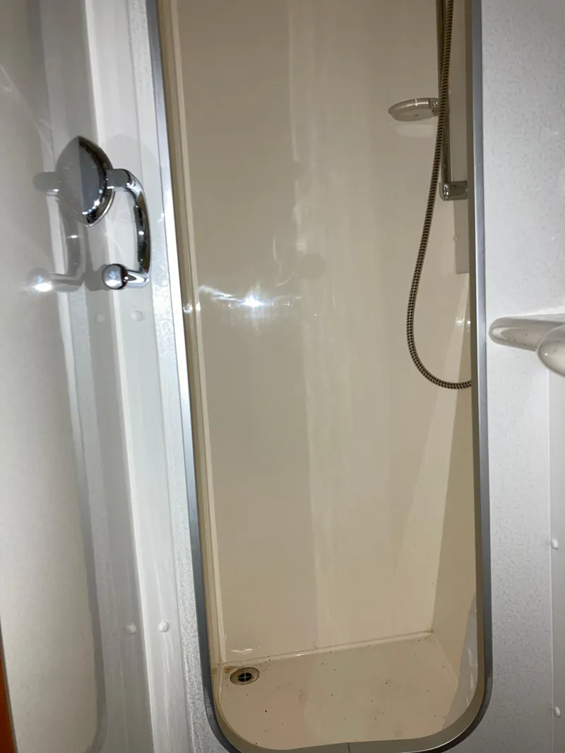 Slide: The Image of Shower area inside a 1997 Sunseeker Manhattan yacht, featuring a sleek design. - 44