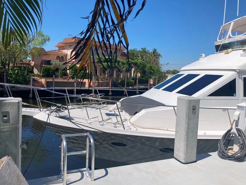 Slide: The Image of 1988 Viking 70 Cockpit Motor Yacht docked at a marina. - 10