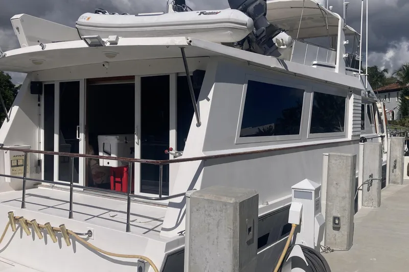 Slide: The Image of 1988 Viking 70 Cockpit Motor Yacht docked, featuring spacious deck and modern amenities. - 15