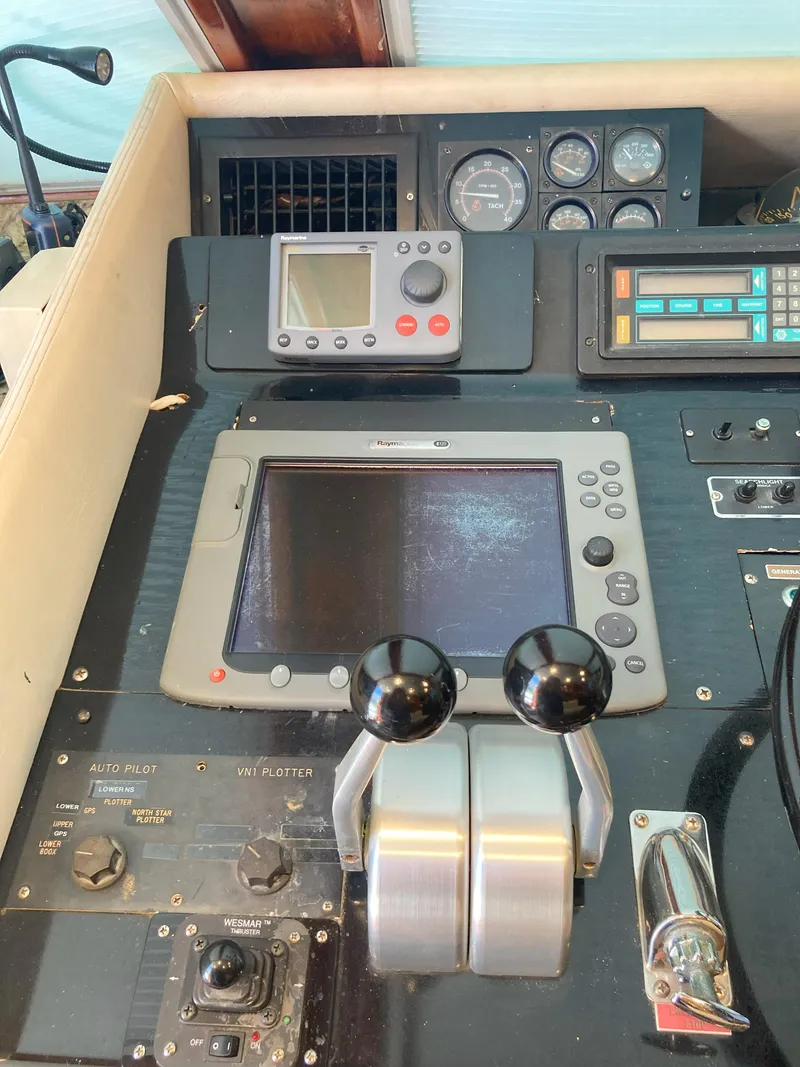 Slide: The Image of Control panel of a 1988 Viking 70 Cockpit Motor Yacht with navigation equipment. - 19