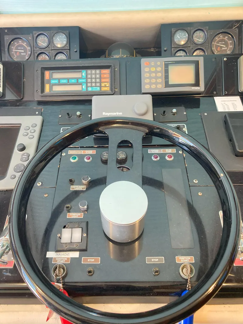 Slide: The Image of Control panel of a 1988 Viking 70 Cockpit Motor Yacht with steering wheel. - 20