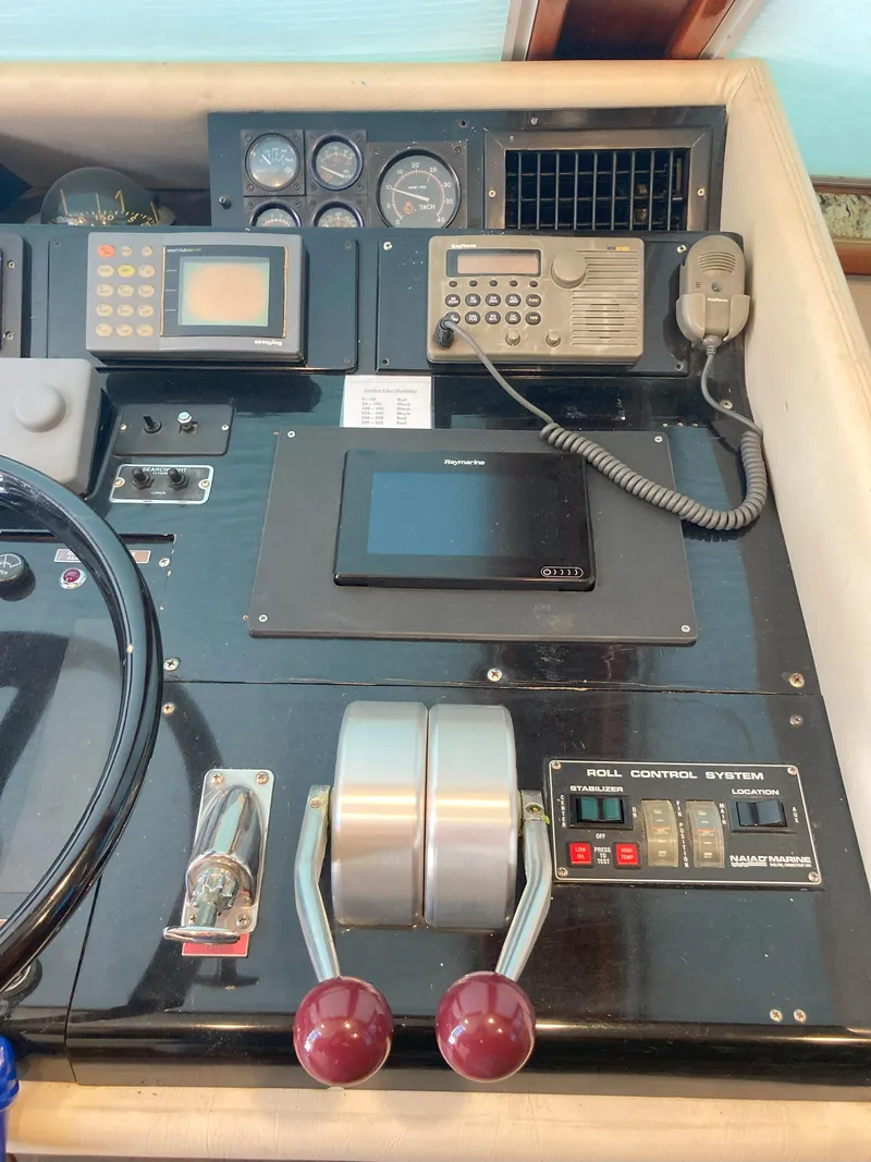 Slide: The Image of Control panel of a 1988 Viking 70 Cockpit Motor Yacht with navigation and communication equipment. - 21