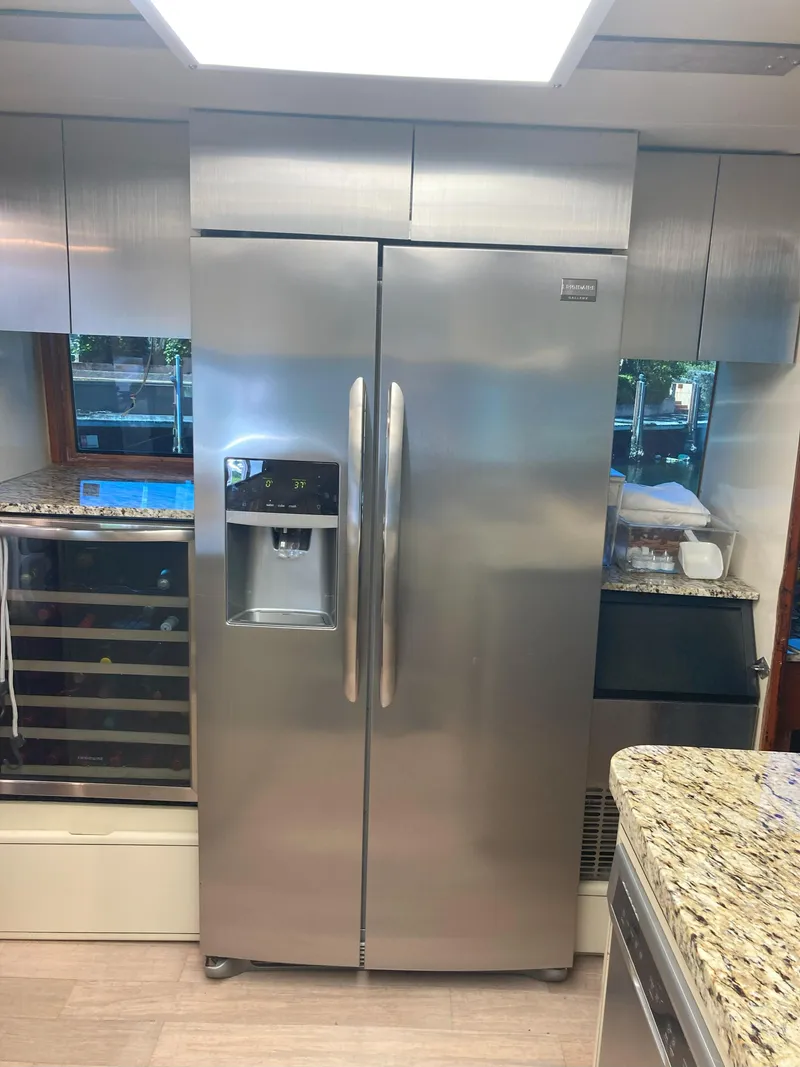 Slide: The Image of Stainless steel refrigerator in the kitchen of a 1988 Viking 70 Cockpit Motor Yacht. - 26