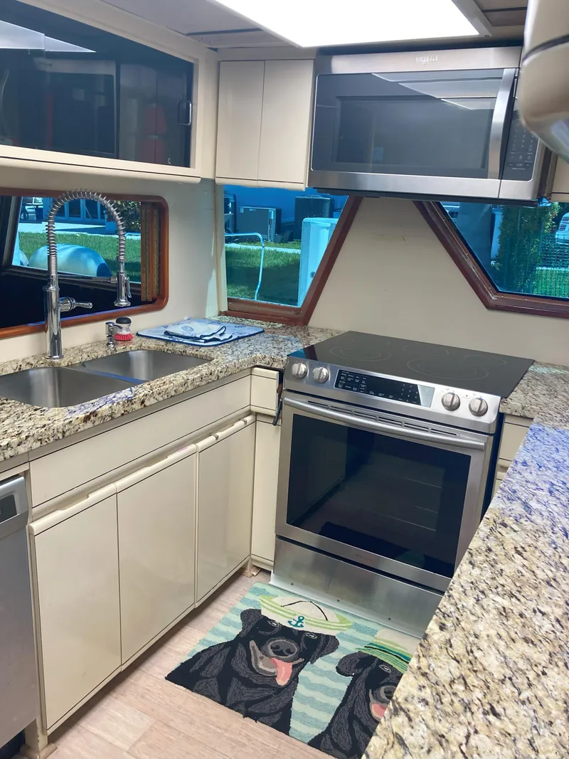 Slide: The Image of Modern kitchen in 1988 Viking 70 Cockpit Motor Yacht with granite countertops. - 27