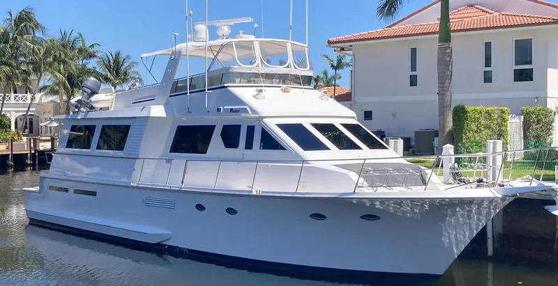 Slide: The Image of 1988 Viking 70 Cockpit Motor Yacht docked near waterfront homes. - 3