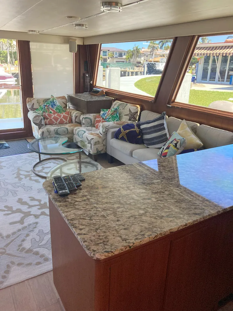 Slide: The Image of Interior of 1988 Viking 70 Cockpit Motor Yacht with plush seating and large windows. - 32