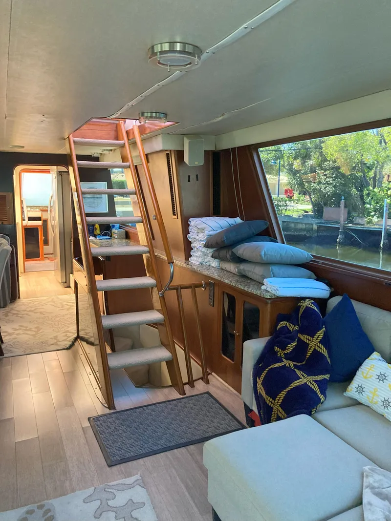 Slide: The Image of Interior of 1988 Viking 70 Cockpit Motor Yacht with stairs and seating area. - 34