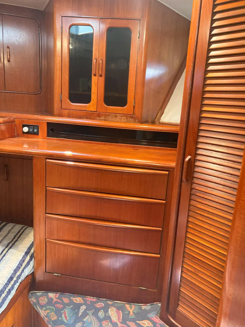 Slide: The Image of Interior cabin of a 1988 Viking 70 Cockpit Motor Yacht with wooden cabinetry. - 37