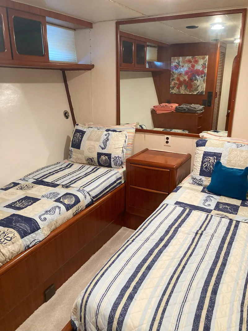 Slide: The Image of Twin beds in the cabin of a 1988 Viking 70 Cockpit Motor Yacht. - 39