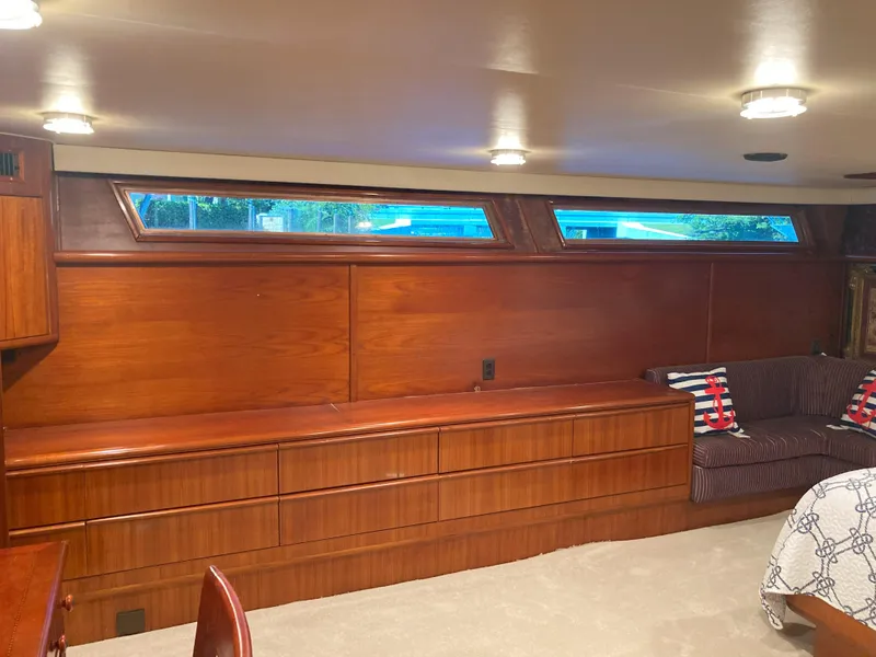 Slide: The Image of Interior of 1988 Viking 70 Cockpit Motor Yacht with wooden cabinetry and seating. - 51