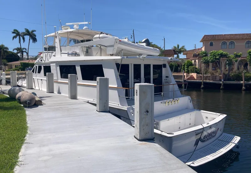 Slide: The Image of 1988 Viking 70 Cockpit Motor Yacht docked at a marina. - 6